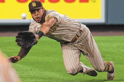 San Diego Padres left fielder Tommy Pham dives to catch a fly ball off the bat of Colorado Rock ...
