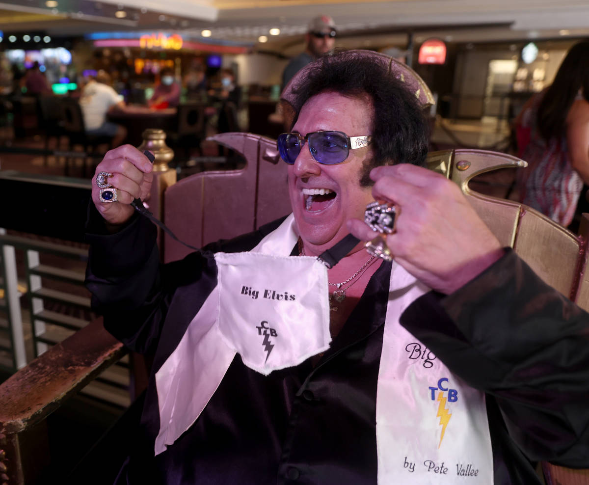 Pete "Big Elvis" Vallee shows his face mask between sets performing at the Piano Bar ...
