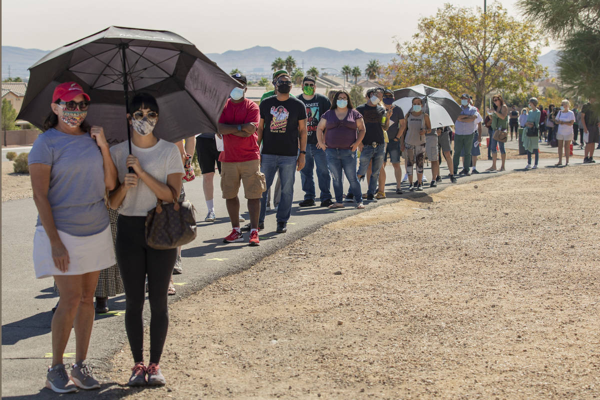 Individuals line up to vote at the event tent located at Desert Breeze Community Center polling ...