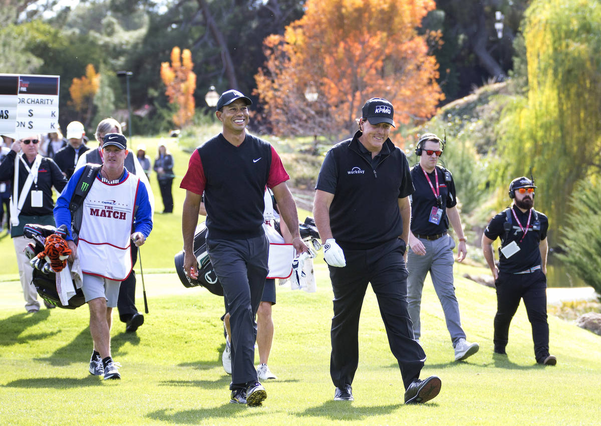 In this Nov. 23, 2018, file photo,Tiger Woods, left, and Phil Mickelson walk to the fairway aft ...