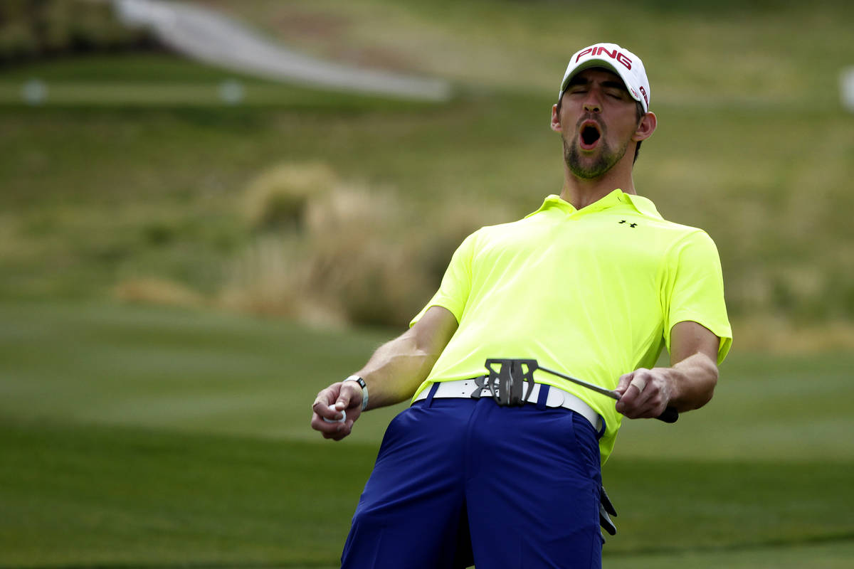 In this April 4, 2013, file photo, Michael Phelps reacts to a put by a teammate during the Mich ...