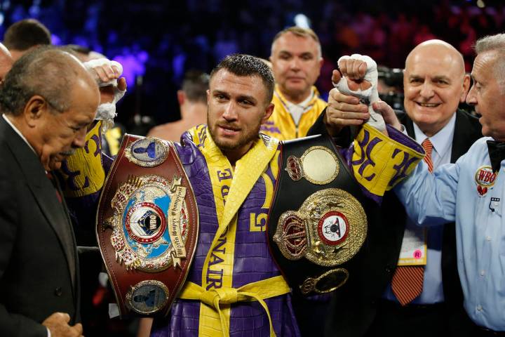 Vasiliy Lomachenko celebrates after defending his WBA/WBO lightweight titles after knocking out ...