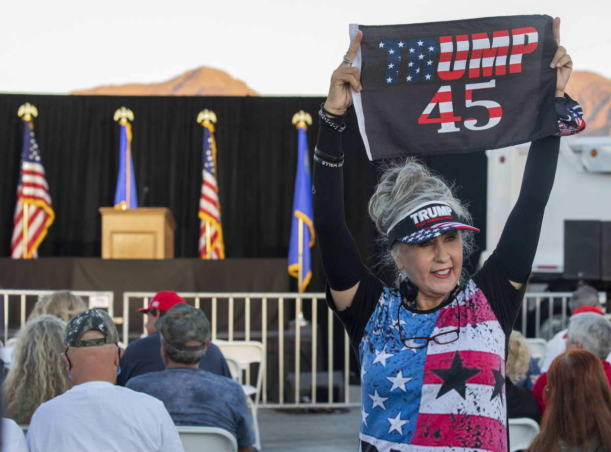 Sharon Abila, 66, of Las Vegas, holds a Trump flag up before Donald Trump Jr. speaks at a campa ...