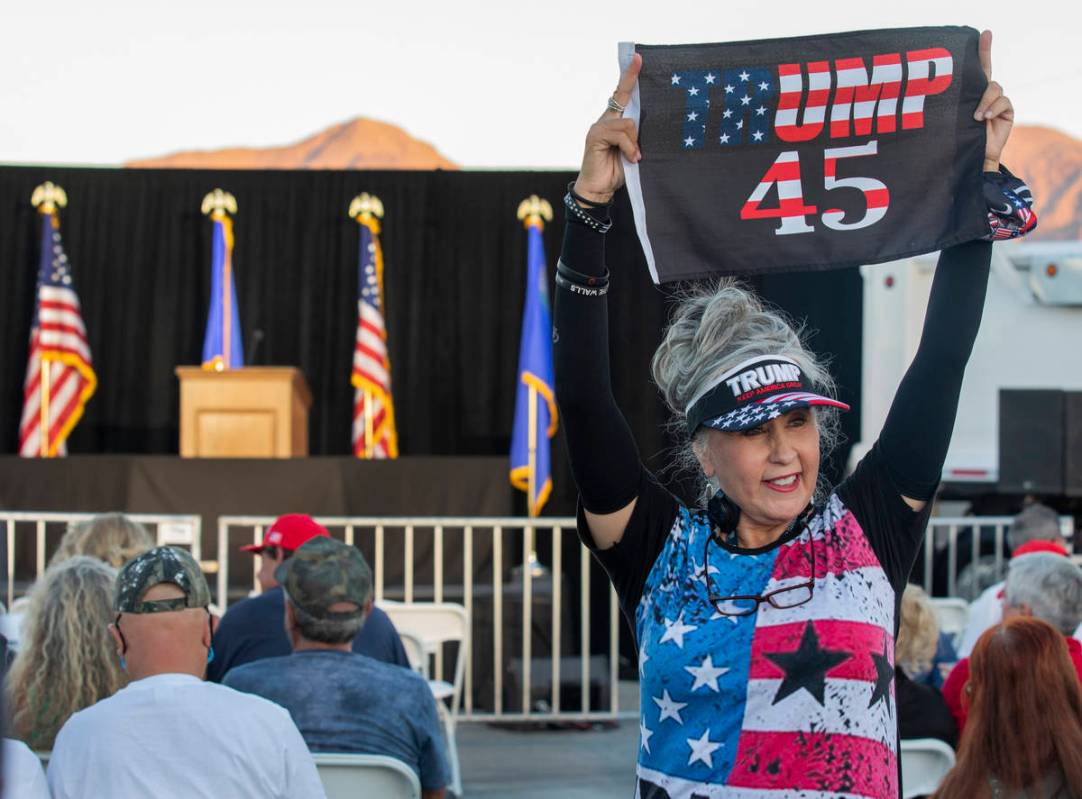 Sharon Abila, 66, of Las Vegas, holds a Trump flag up before Donald Trump Jr. speaks at a campa ...