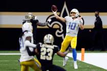 Los Angeles Chargers quarterback Justin Herbert (10) throws the ball in front of New Orleans Sa ...