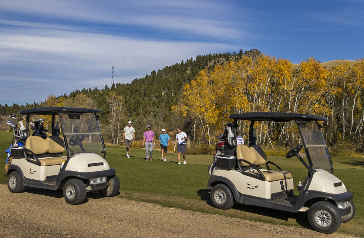 Players finish their round at the 18th hole of Rock Creek Cattle Company golf course on Friday, ...