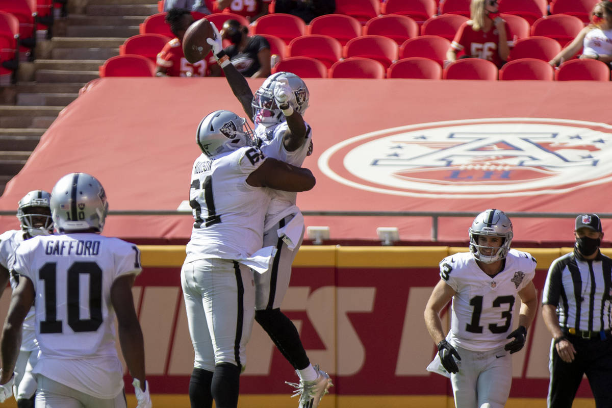 Las Vegas Raiders wide receiver Henry Ruggs III (11) celebrates his touchdown score with center ...