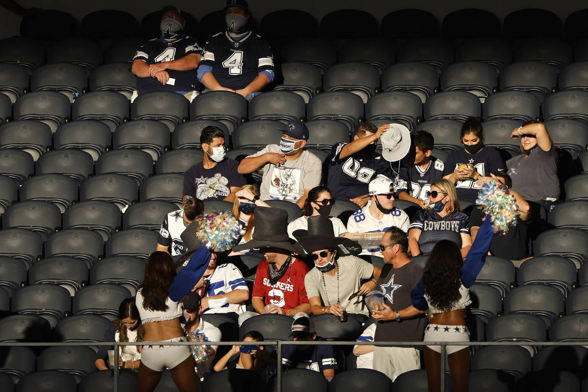 Fans watch a game between the Dallas Cowboys and the New York Giants in the second half of an N ...