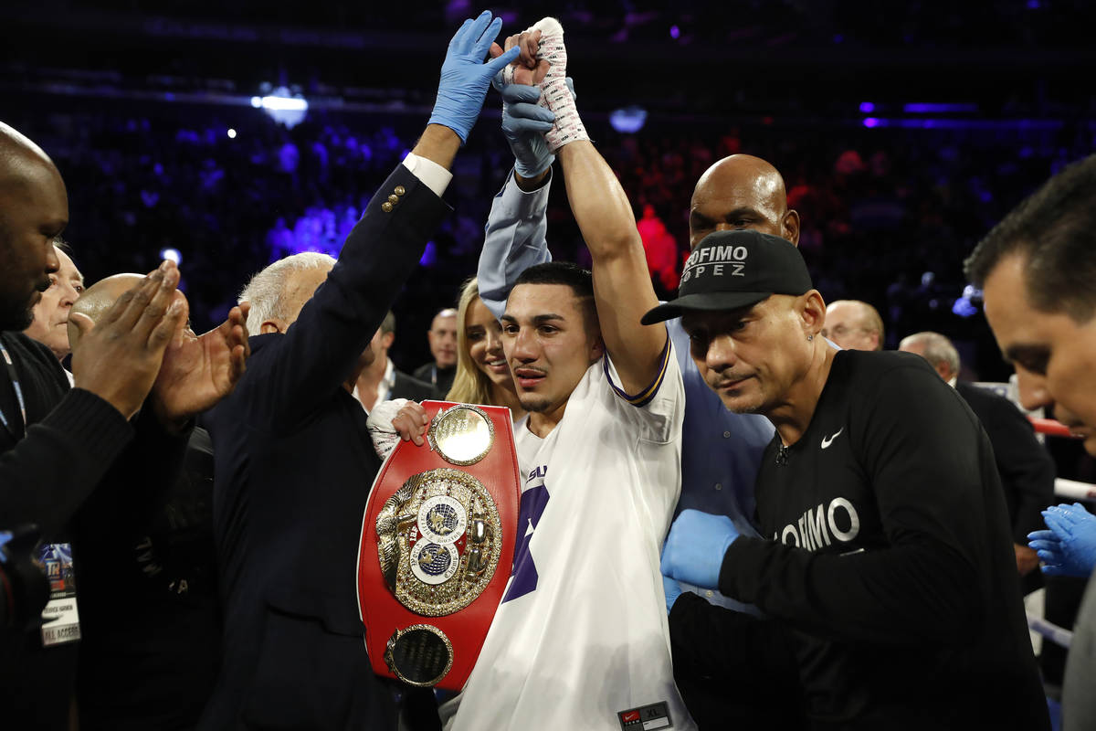 Teofimo Lopez, center, reacts after defeating Ghana's Richard Commey by TKO during the second r ...