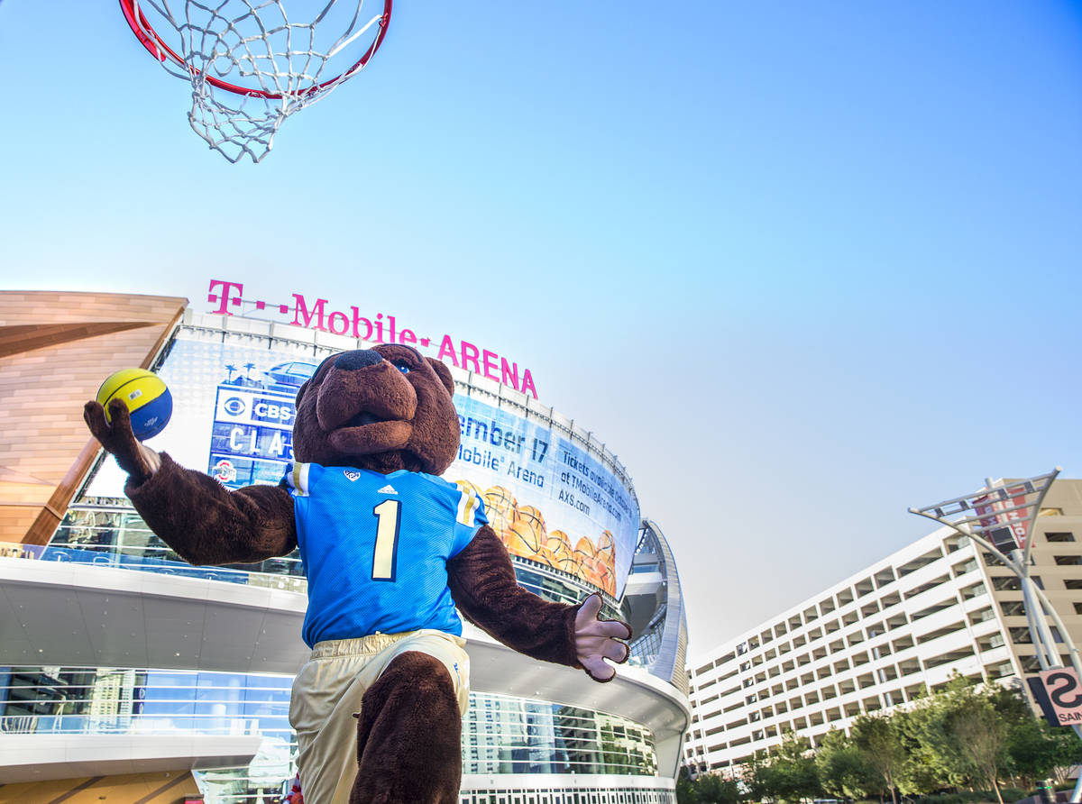 UCLA mascot Joe Bruin drives for a layup on Tuesday, Oct. 11, 2016, outside T-Mobile Arena, in ...
