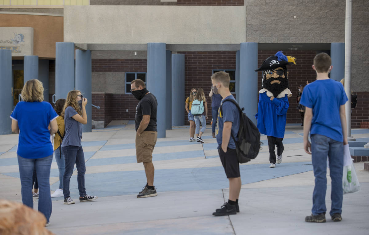 Students and adults gather outside at Moapa Valley High School before the start of classes with ...