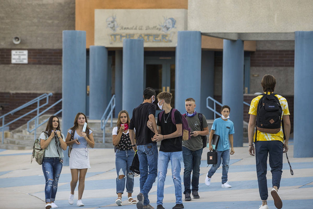 Students greet each other outside at Moapa Valley High School before the start of classes with ...