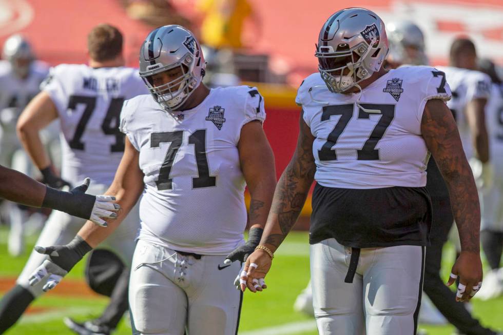 Las Vegas Raiders offensive tackle Denzelle Good (71) and Las Vegas Raiders offensive tackle Tr ...