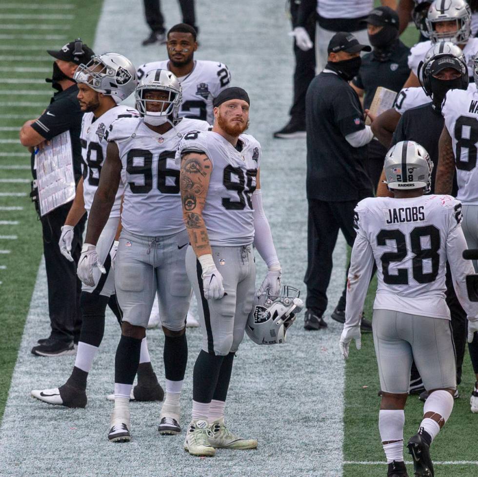 Las Vegas Raiders defensive ends Clelin Ferrell (96) and Maxx Crosby (98) look up at a replay o ...