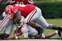 Tennessee quarterback Jarrett Guarantano (2) is brought down by Georgia defensive lineman Julia ...