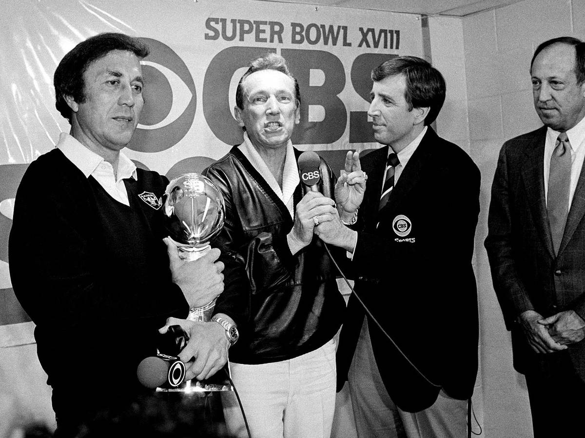 FILE - In this Jan. 23, 1984, file photo, Oakland Raiders coach Tom Flores clutches the Super B ...