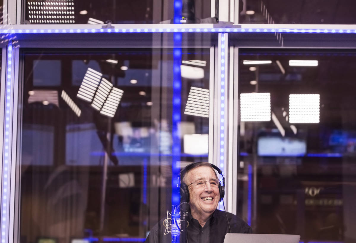 Brent Musburger shares a laugh with staff members during a live broadcast covering opening rou ...