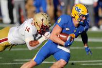 Pittsburgh quarterback Kenny Pickett (8) evades Boston College linebacker Max Richardson during ...