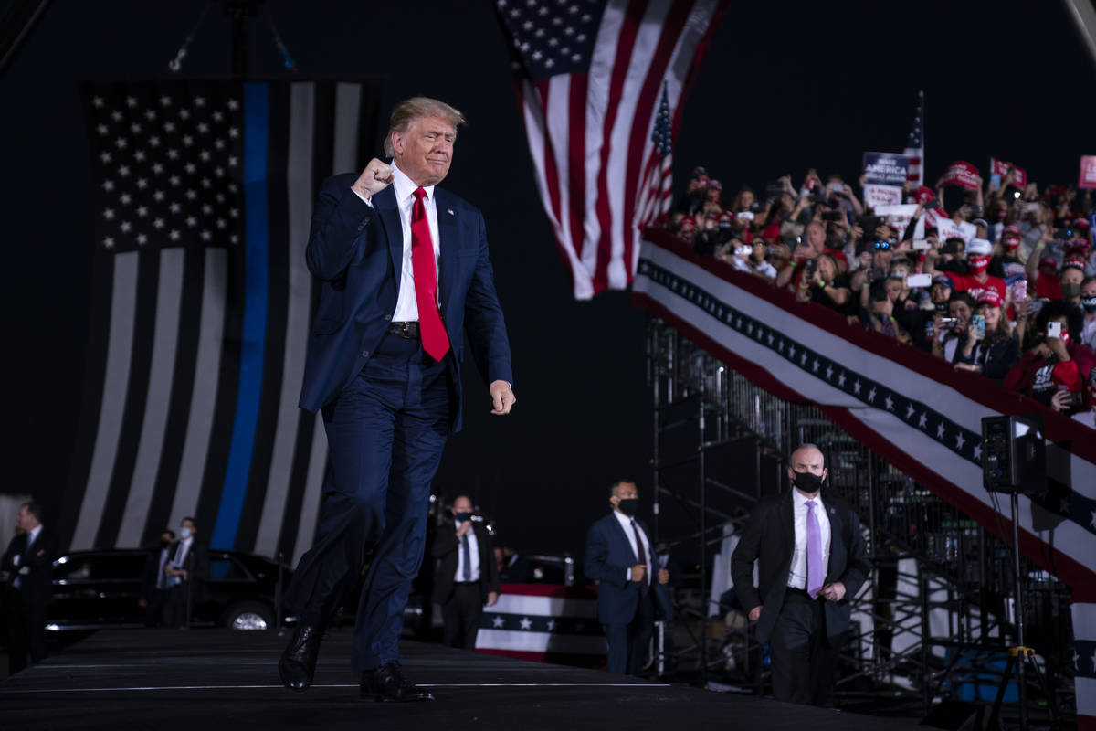 President Donald Trump arrives to speak to a campaign rally at Middle Georgia Regional Airport, ...
