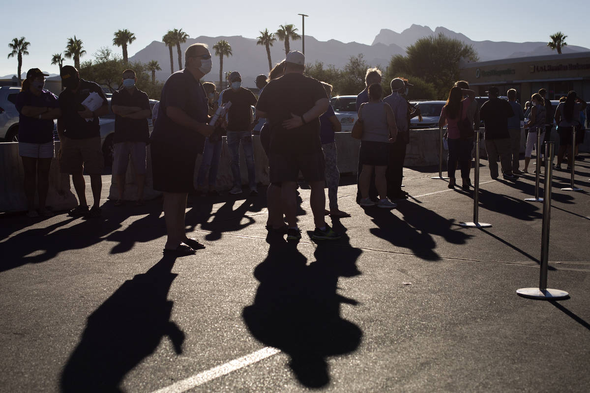 Voters wait in line at the early voting location in the parking lot of Centennial Center Home D ...