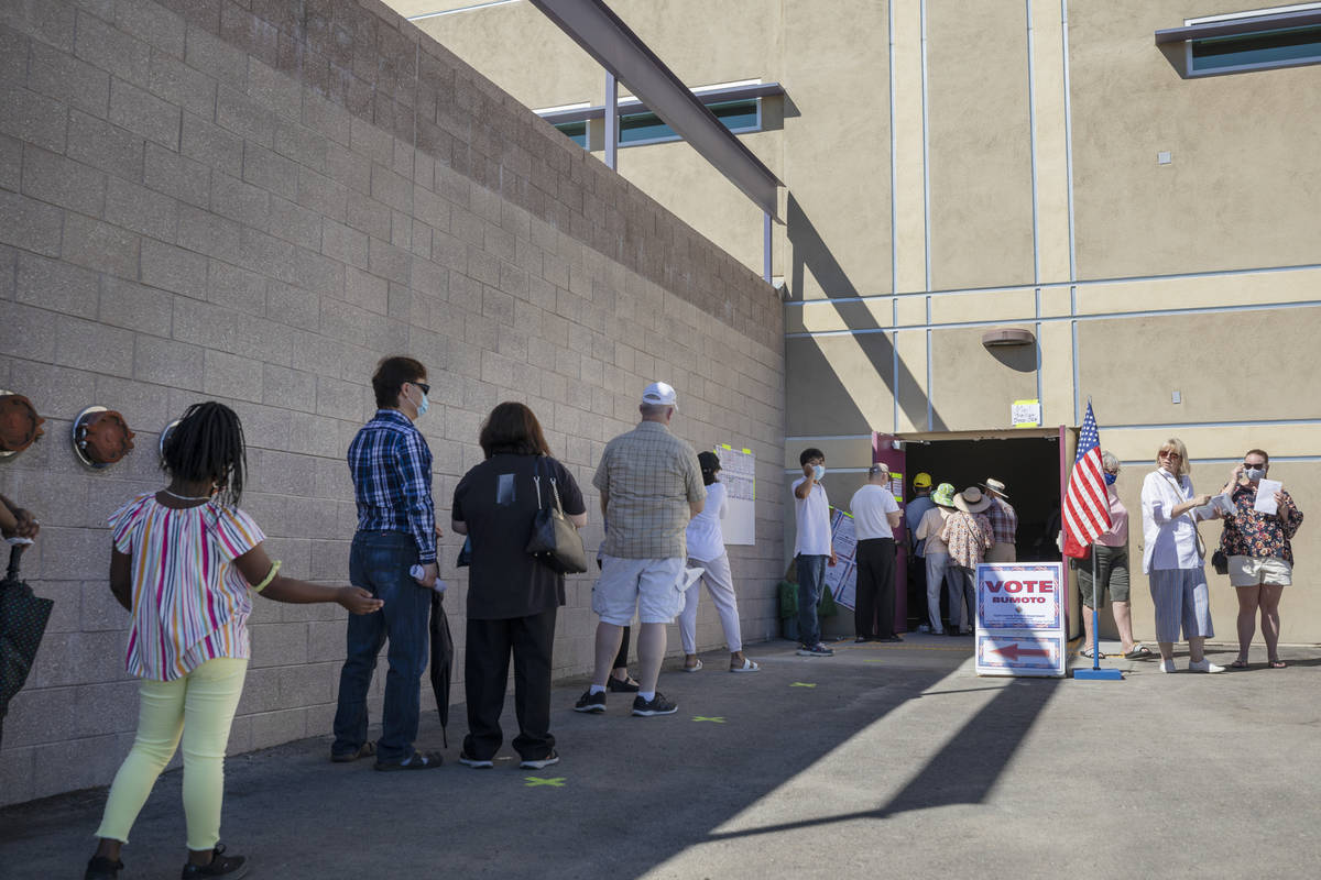 Individuals line up to vote at the event tent located at Desert Breeze Community Center polling ...