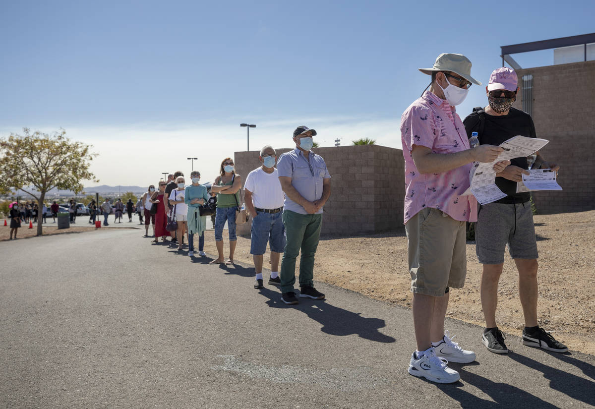 Individuals line up to vote at the event tent located at Desert Breeze Community Center polling ...