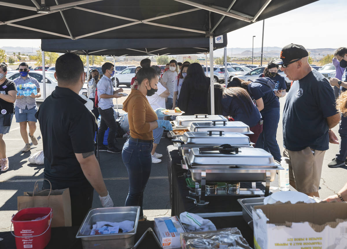 Individuals are served free food at the Desert Breeze Community Center polling site, on Saturda ...