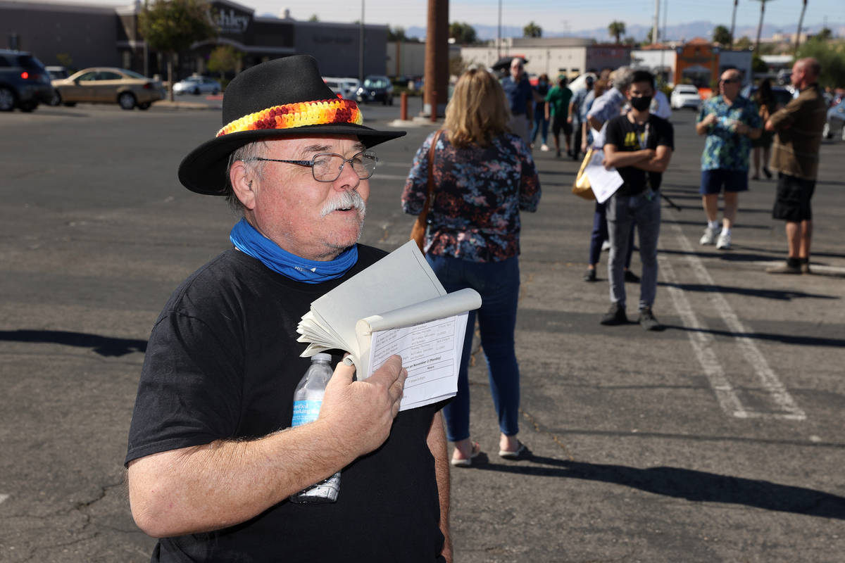 Patrick Lear waits in line to cast his vote at the Galleria at Sunset polling location in Hende ...