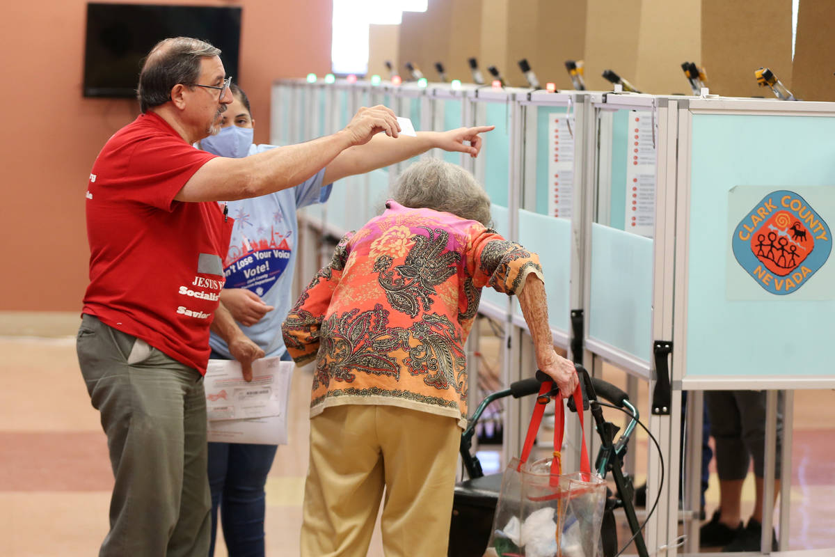 Kim Blandino, left, and Evelyn Pendergraft, receive assistance from poll monitor Yobana Gracian ...