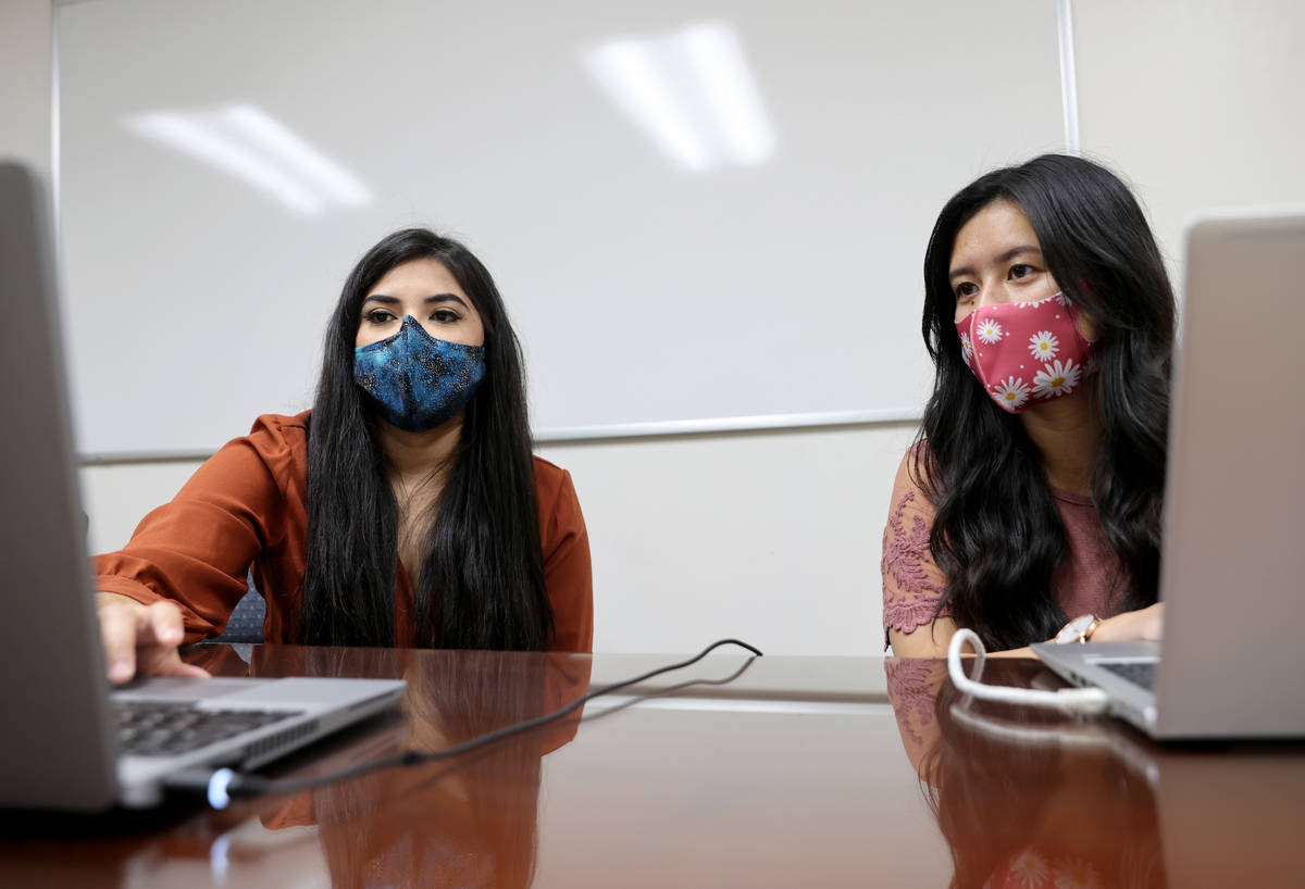 Karen Gutierrez, left, trains fellow UNLV student Leanne Villanueva on the school's COVID-19 co ...