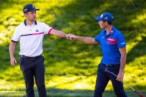 Xander Schauffele, left, fist bumps Viktor Hovland after finishing the second round of the CJ C ...