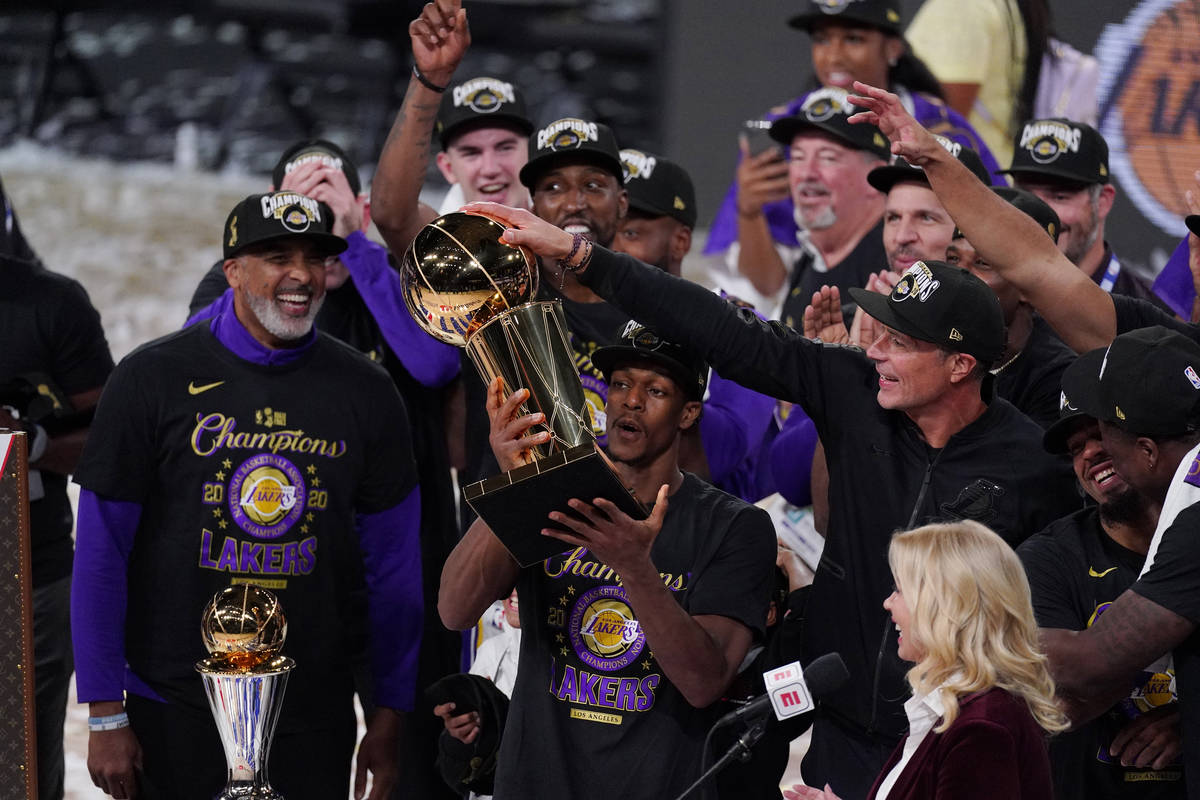 Los Angeles Lakers' Rajon Rondo (9) holds the trophy as he celebrates with his teammates after ...