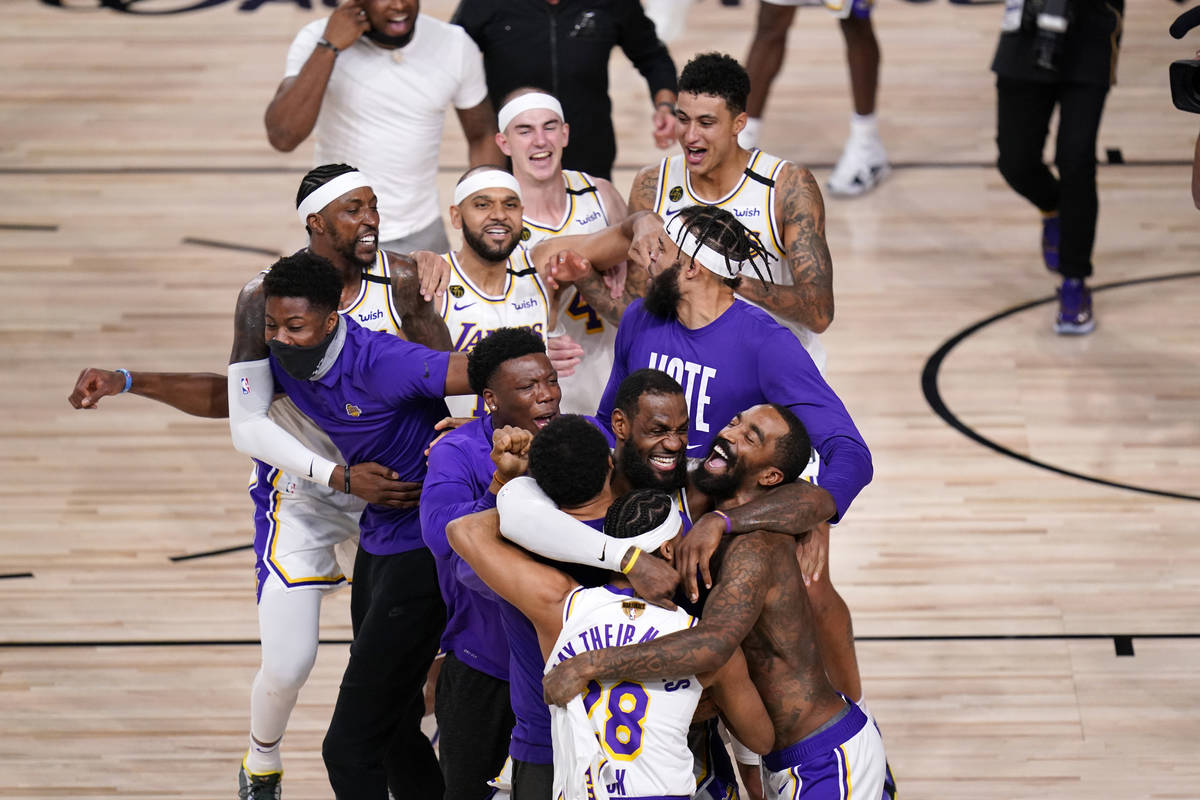 The Los Angeles Lakers players and coaches celebrate after the Lakers defeated the Miami Heat 1 ...