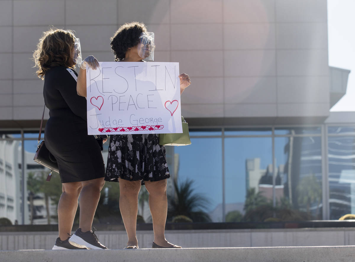 Traci Rawlinson, left, and her mother Judge Johnnie B. Rawlinson pay respects as a police-escor ...