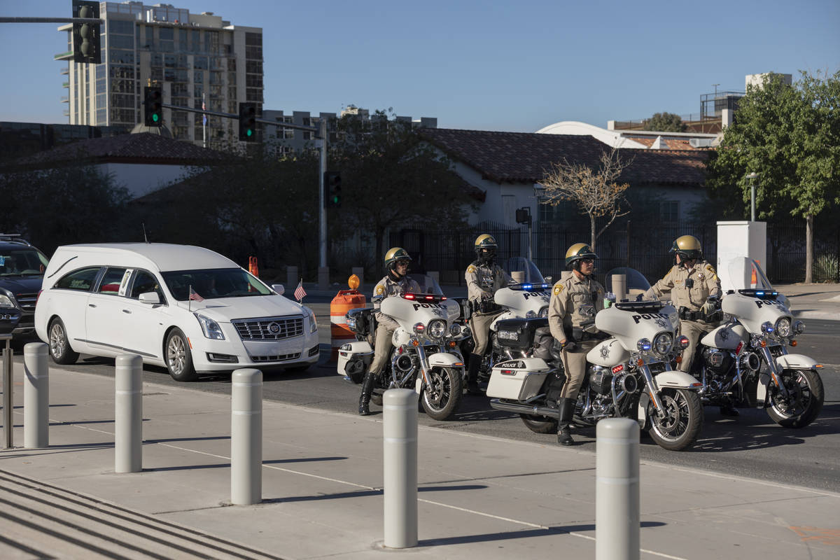 A police-escorted motorcade arrive at the front of the Lloyd D. George Federal Courthouse to ho ...