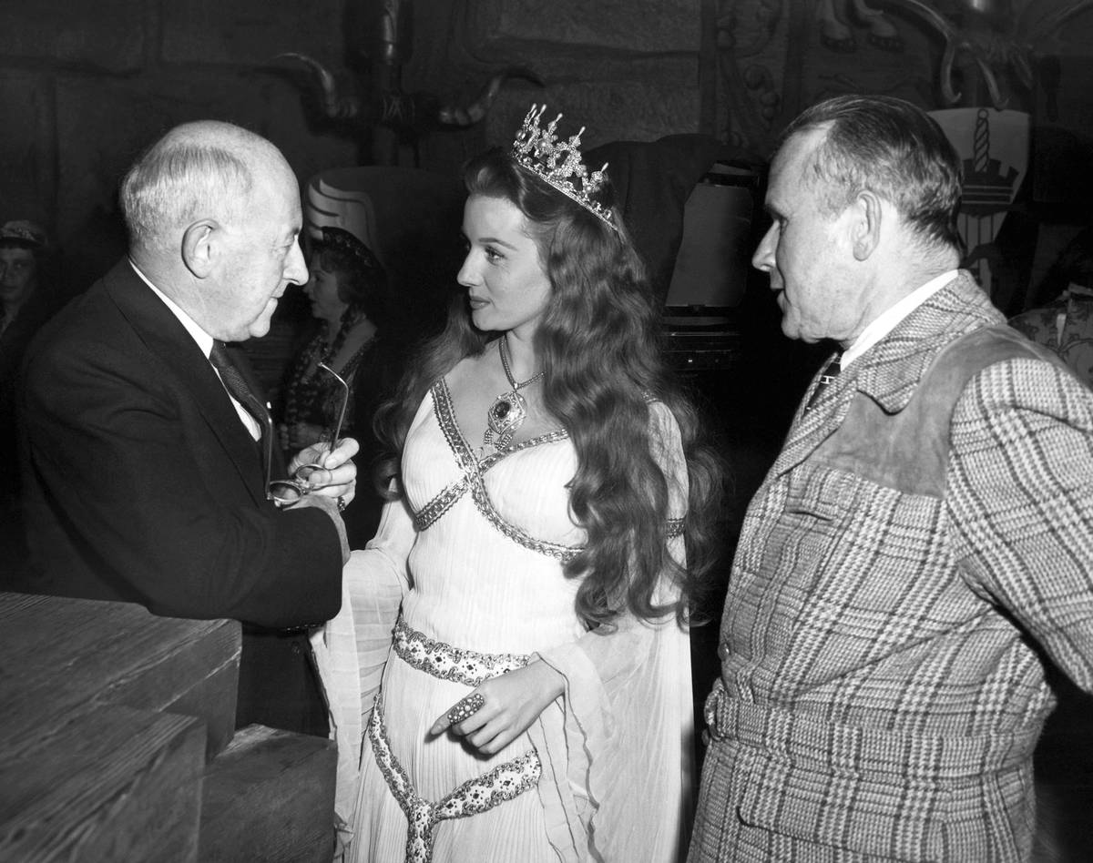 FILE - In this Dec. 16, 1947 file photo, Producer- director Cecil B. DeMille, left, gives actre ...