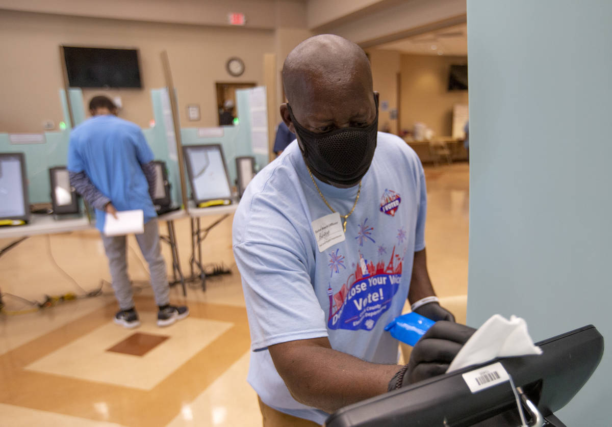 Rodney Jefferson cleans a voting machine at Doolittle Community Center during early voting on S ...