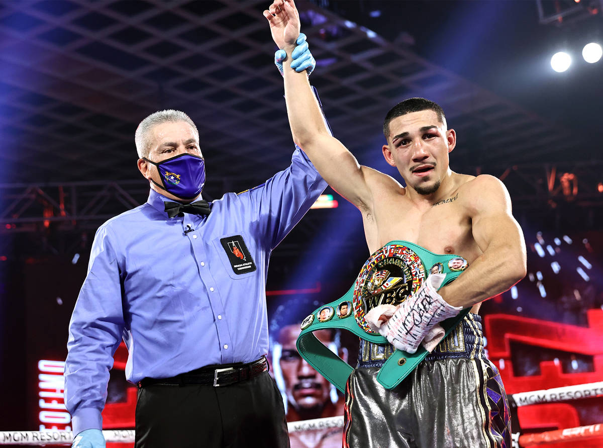 Teofimo Lopez has his arm raised in victory after his unanimous decision over Vasiliy Lomachenk ...