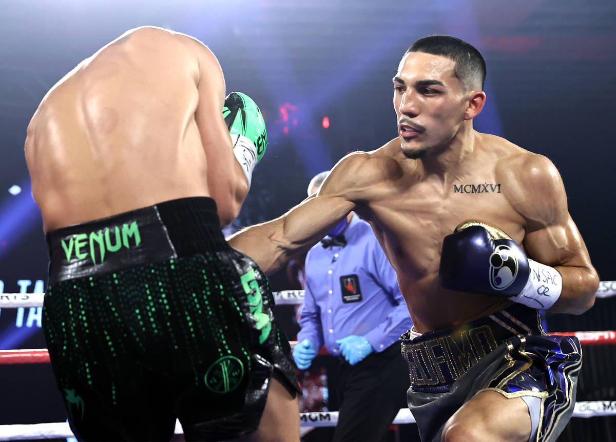 Teofimo Lopez, right, lands a punch against Vasiliy Lomachenko during their lightweight title f ...
