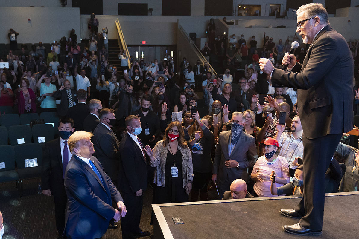 President Donald Trump, lower left, attends church at International Church of Las Vegas, as Pas ...