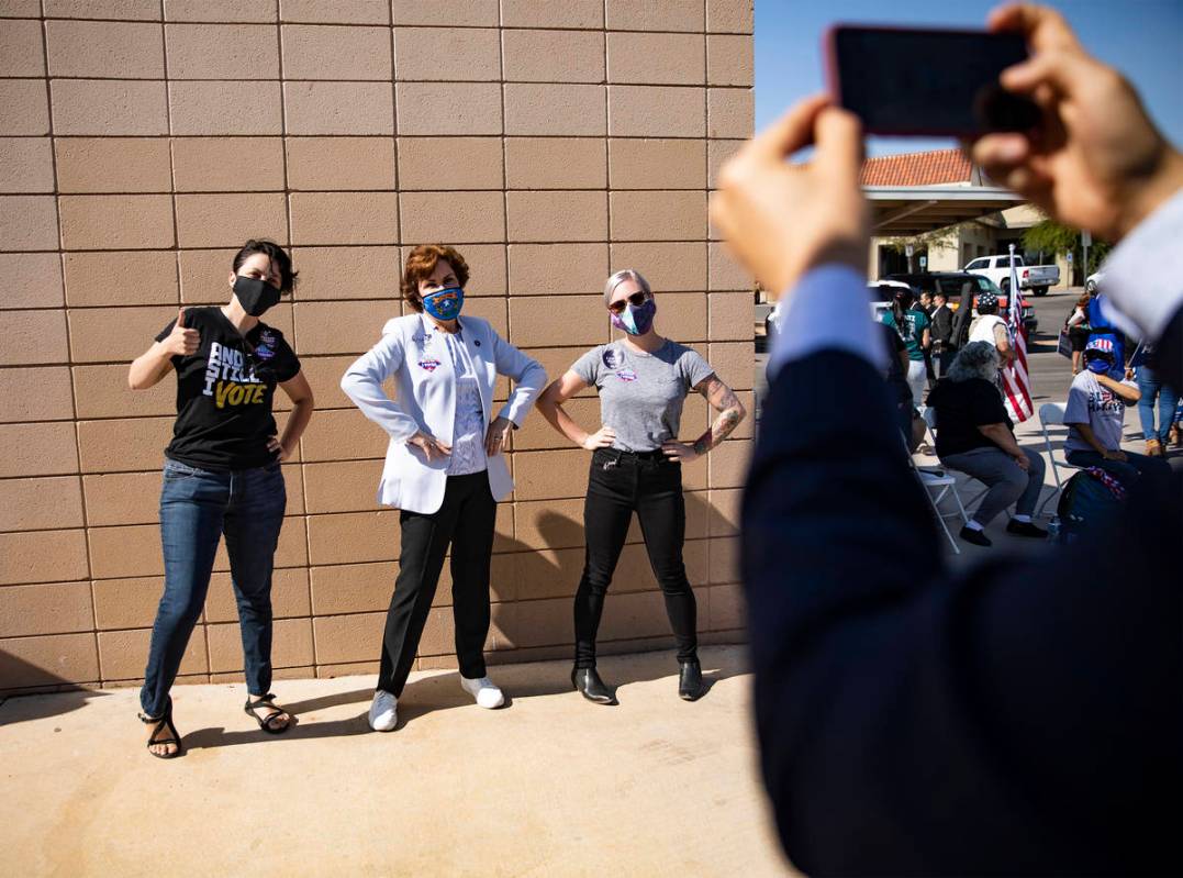 April Lalone, left, takes a photo with Sen. Jacky Rosen, D-Nev., center, and LaloneÕs fian ...