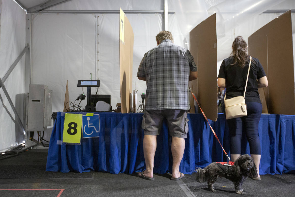 Voters cast their ballots at the Meadows Mall early voting location on Sunday, Oct. 18, 2020, i ...