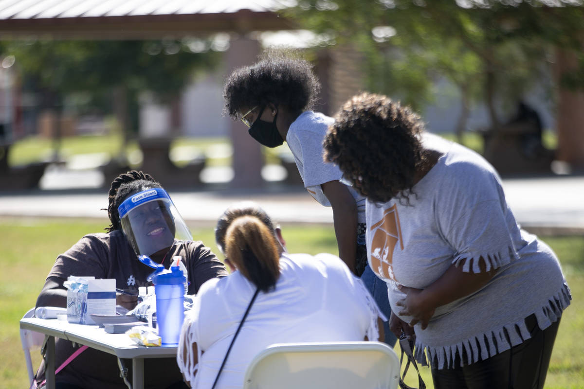 Tanisha Ranger, left, checks people in for the Souls to the Polls event at Kianga Isoke Palacio ...