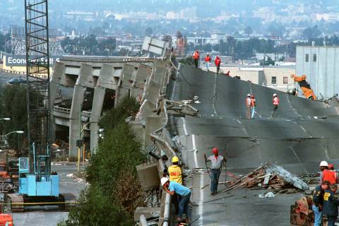 Workers check the damage to Interstate 880 in Oakland, Ca. on Thursday, Oct. 19, 1989. The fre ...