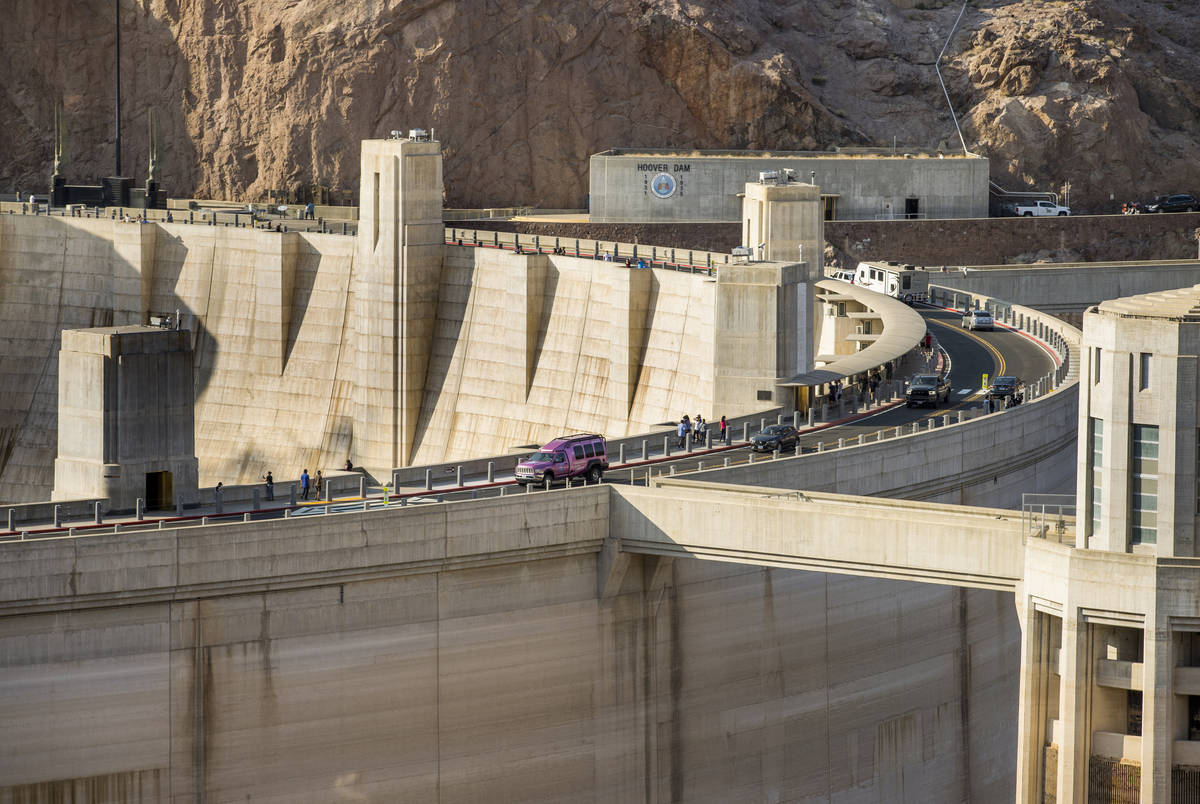 Visitors view Hoover Dam, which reopeed to the public after being closed for months due to COVI ...
