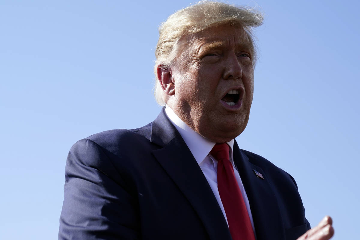 President Donald Trump speaks to reporters at Phoenix Sky Harbor International Airport, Monday, ...