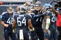 Tennessee Titans running back Derrick Henry (22) is mobbed by teammates after Henry scored the ...