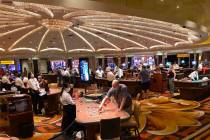 Gamblers don protective face masks at Caesars Palace on the Las Vegas Strip in this June 24, 20 ...