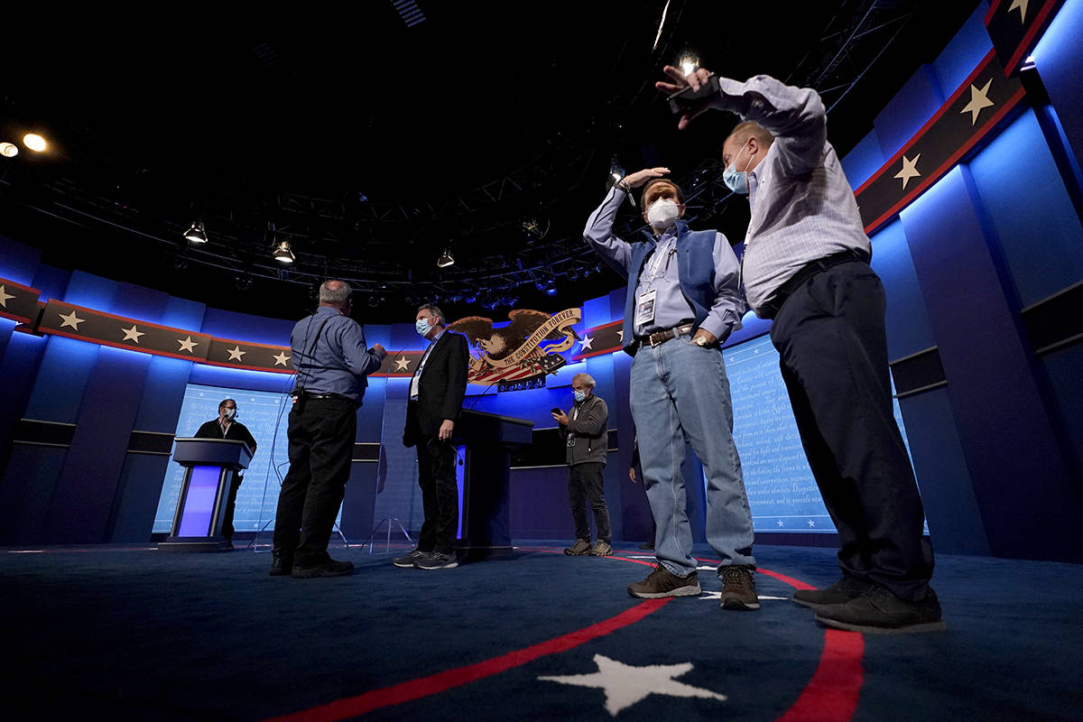 Production crew member stand on stage ahead of the final presidential debate between Republican ...