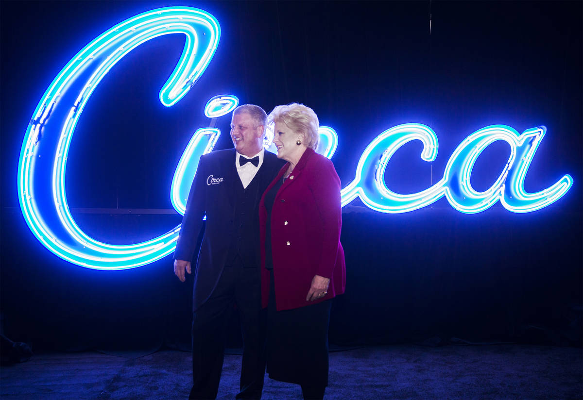 Developer Derek Stevens, left, and Mayor Carolyn Goodman take photos in front of neon signage f ...